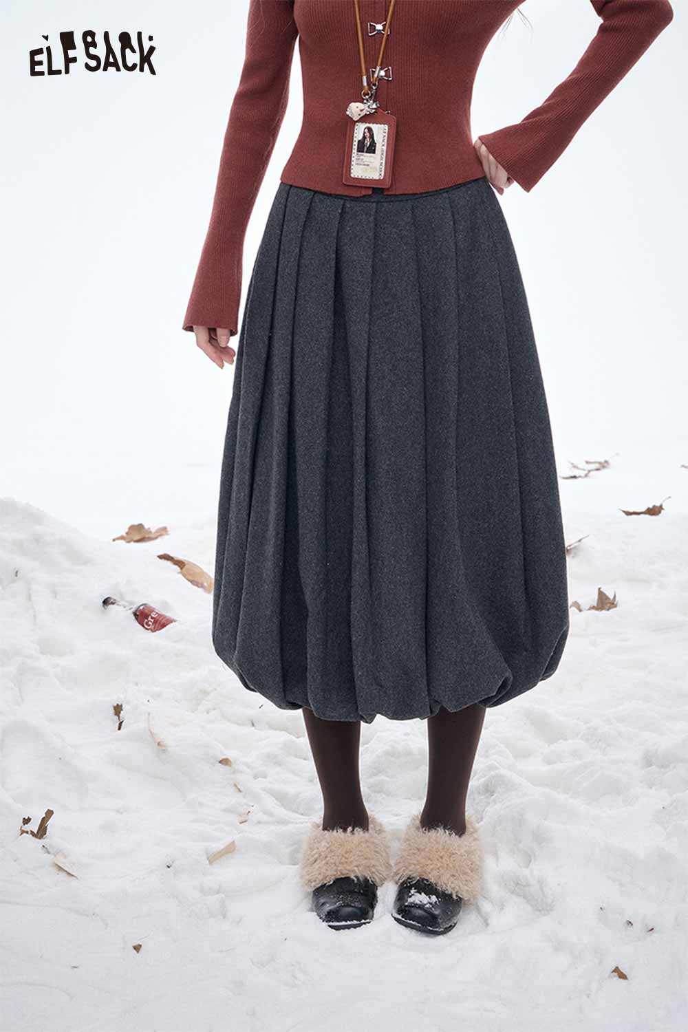 ELFSACK dark gray pleated half skirt with a stylish balloon silhouette and cozy top in winter setting