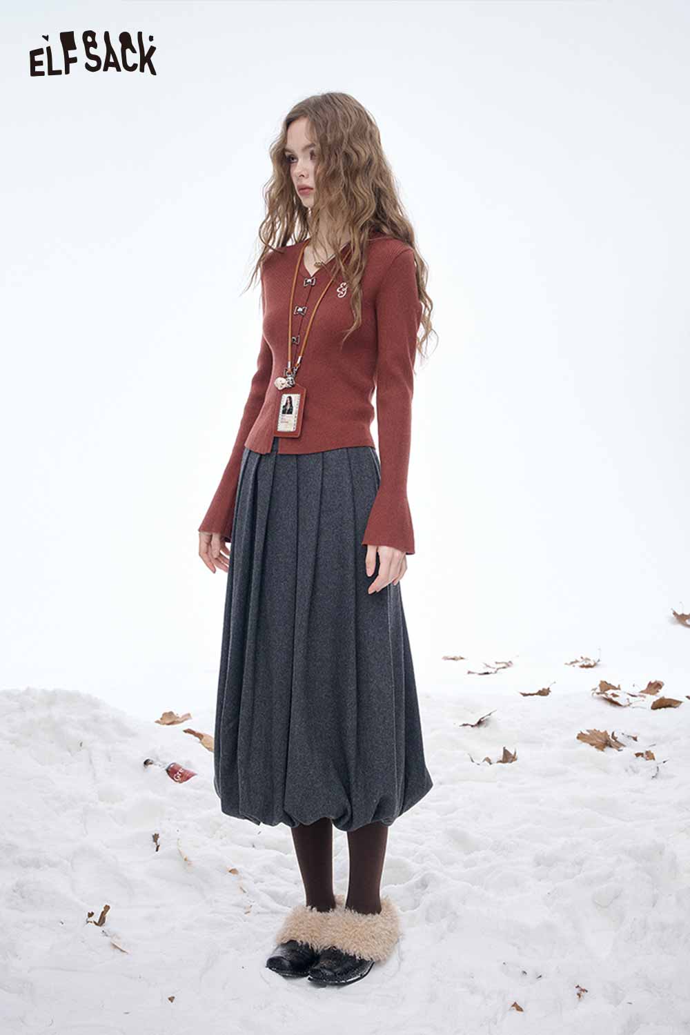 ELFSACK dark gray pleated half skirt styled with a maroon sweater for a chic winter look