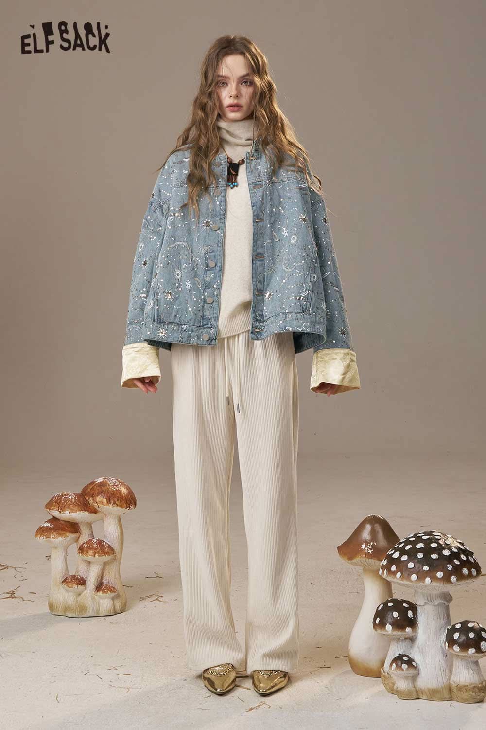 ELFSACK denim glitter accent jacket styled with a cream outfit and surrounded by decorative mushrooms
