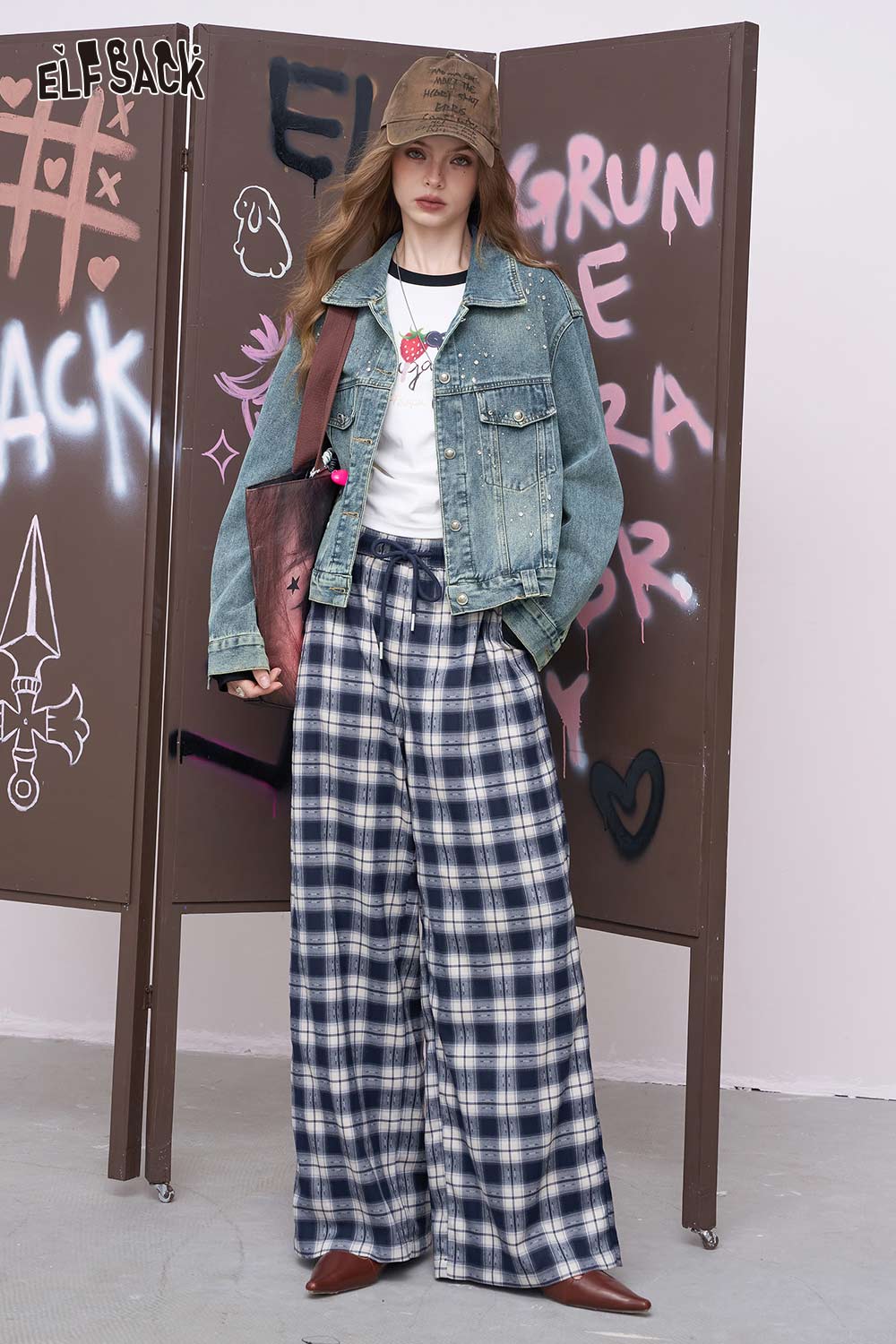ELFSACK model wearing women's diamond embellished denim jacket with white tee plaid wide leg pants and cap
