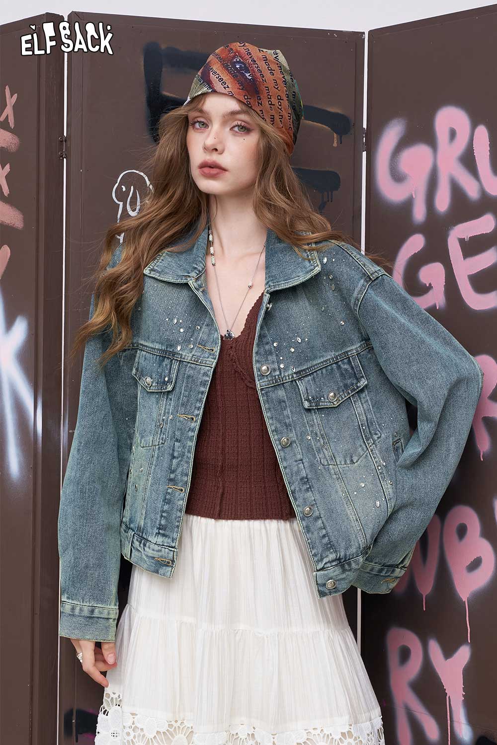 ELFSACK model wearing women's diamond embellished denim jacket in light wash oversized fit with boho scarf