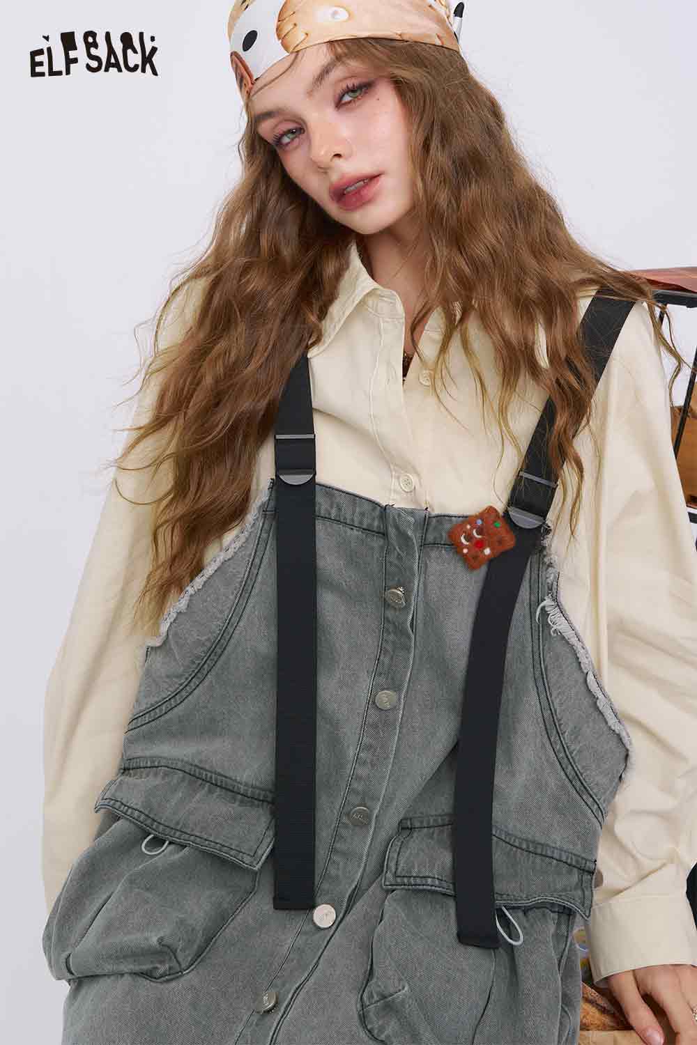 ELFSACK model wearing a denim color-block midi dress with black suspenders large patch pockets and cream shirt