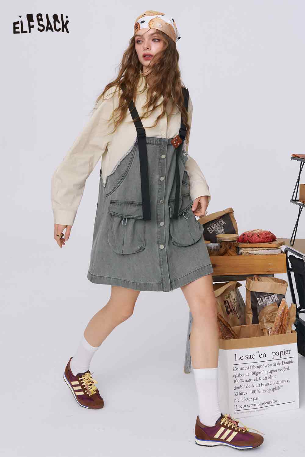 ELFSACK model wearing denim color-block midi dress pinafore with front pockets straps styled with sneakers and scarf