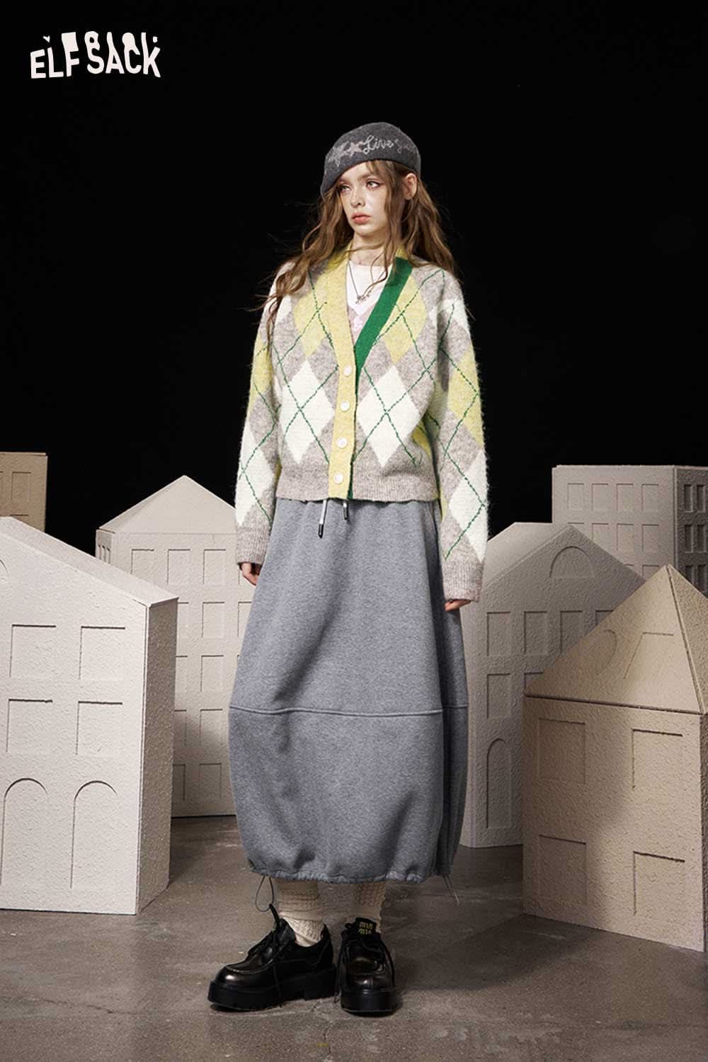 ELFSACK diamond pattern v neck sweater in yellow and gray paired with a long skirt