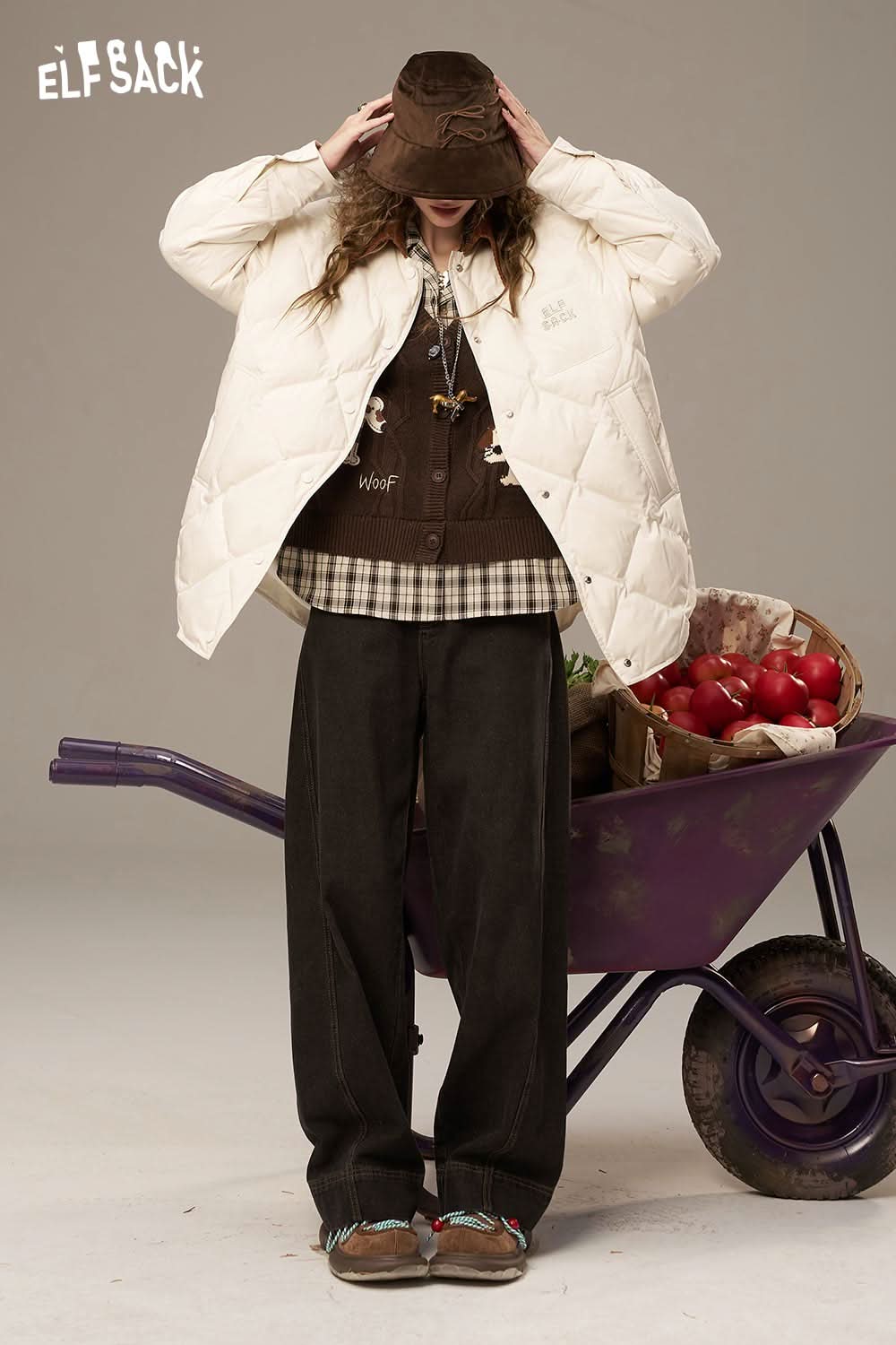 ELFSACK diamond quilted down coat in white, styled over a layered outfit with a bucket hat