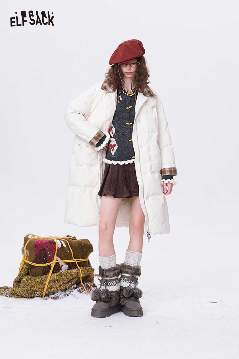 ELFSACK double breasted bow sweater layered under a stylish white coat and paired with a fashionable skirt