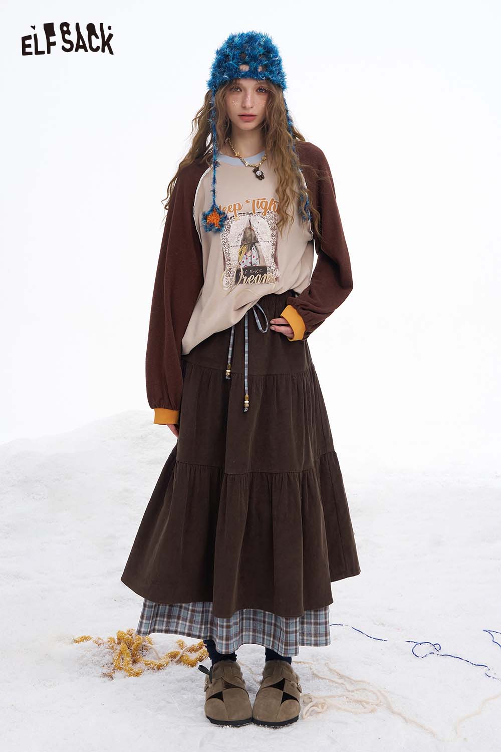 ELFSACK double layer long skirt for women in a stylish layered design, paired with a graphic sweatshirt