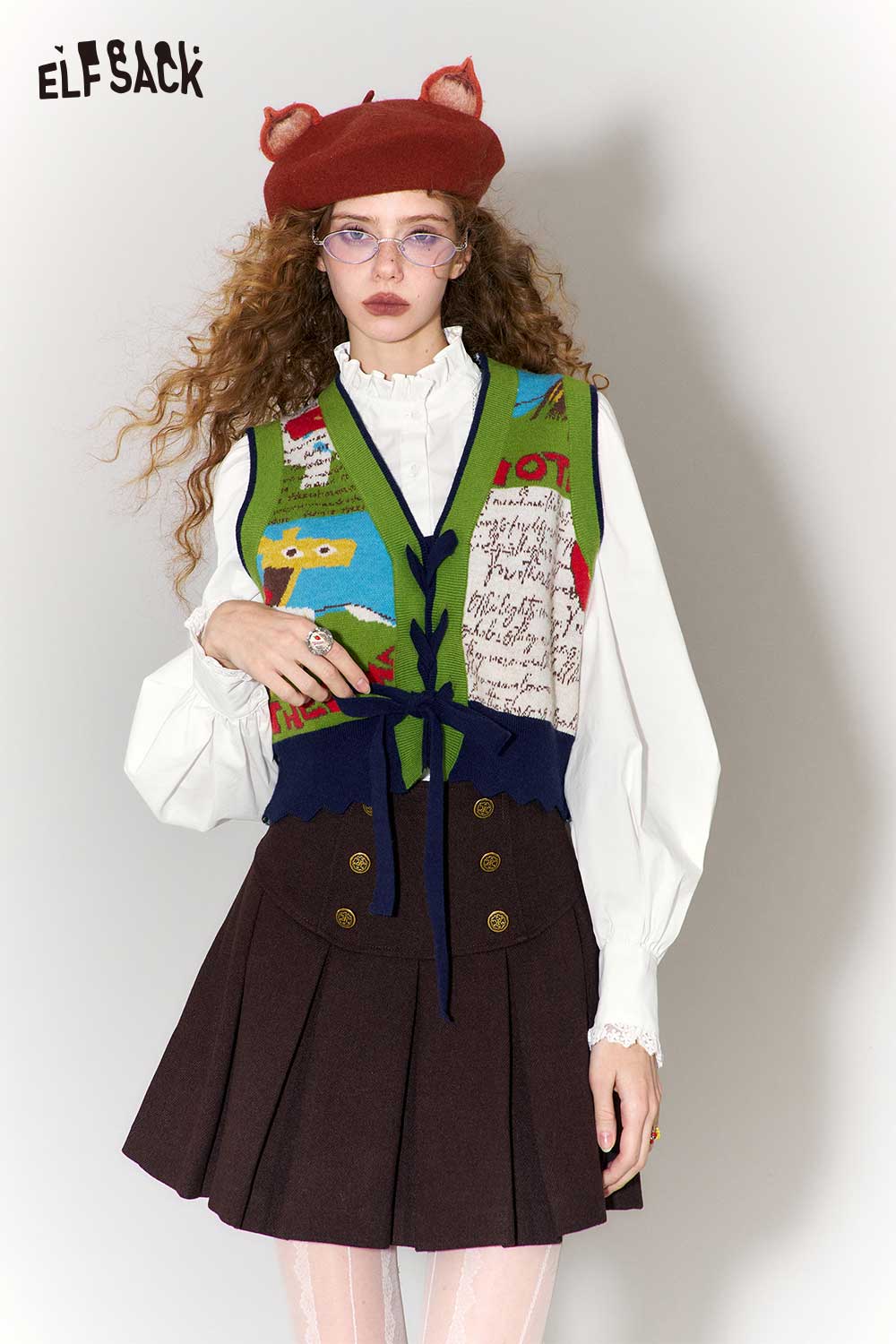 Elegant ruffle collar white shirt worn under a colorful vest and styled with a chic skirt