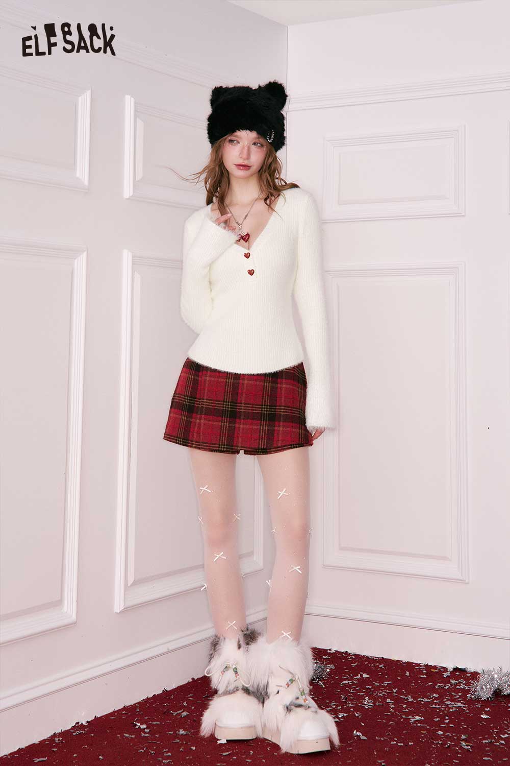 Elegant v neck sweater women in cream paired with a plaid skirt and winter accessories
