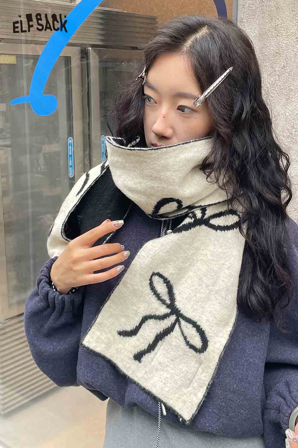 Woman wearing ELFSACK bow graphic neck warmer for stylish winter protection