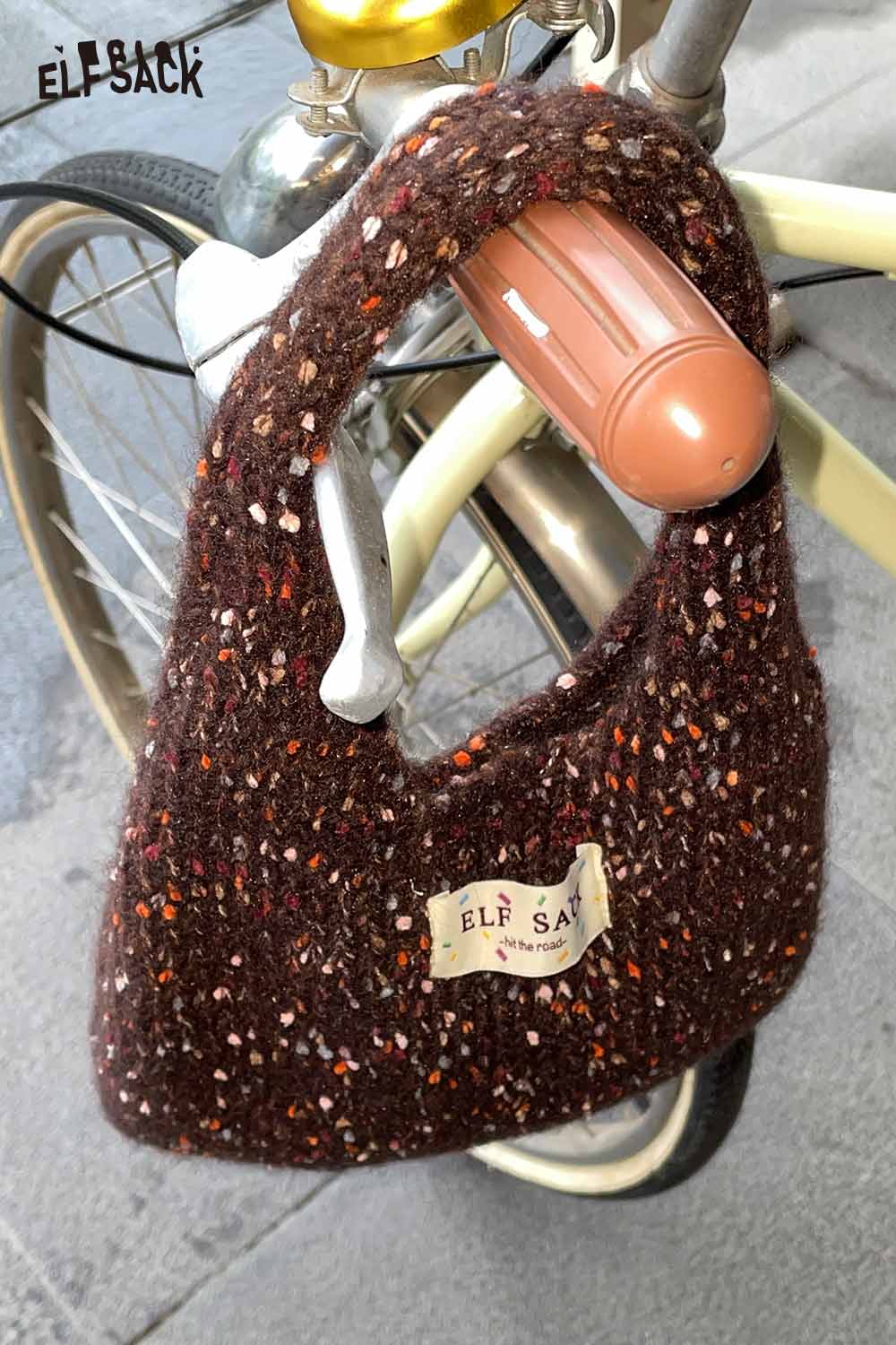 ELFSACK color block handwoven tote bag displayed on a bicycle handle for stylish everyday use