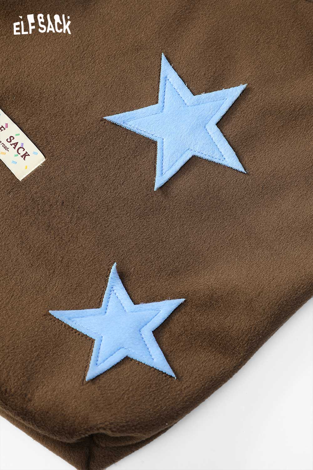 ELFSACK color block star tote bag featuring blue star appliques on a brown background