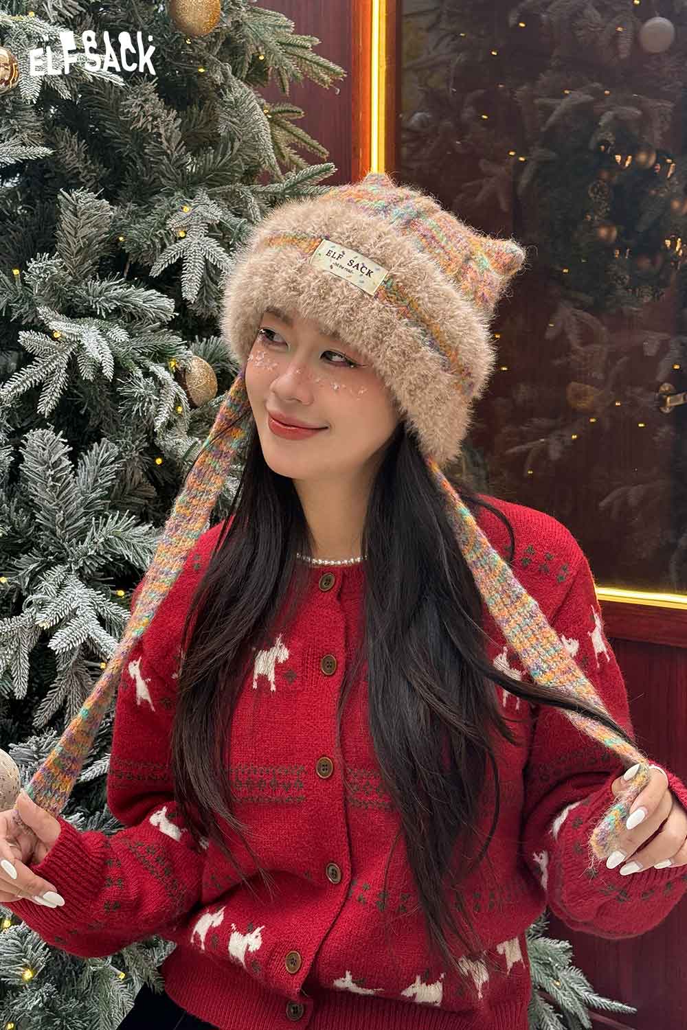 Woman wearing a colorful cute cat ear beanie for women with long ties, cozy and stylish for winter.