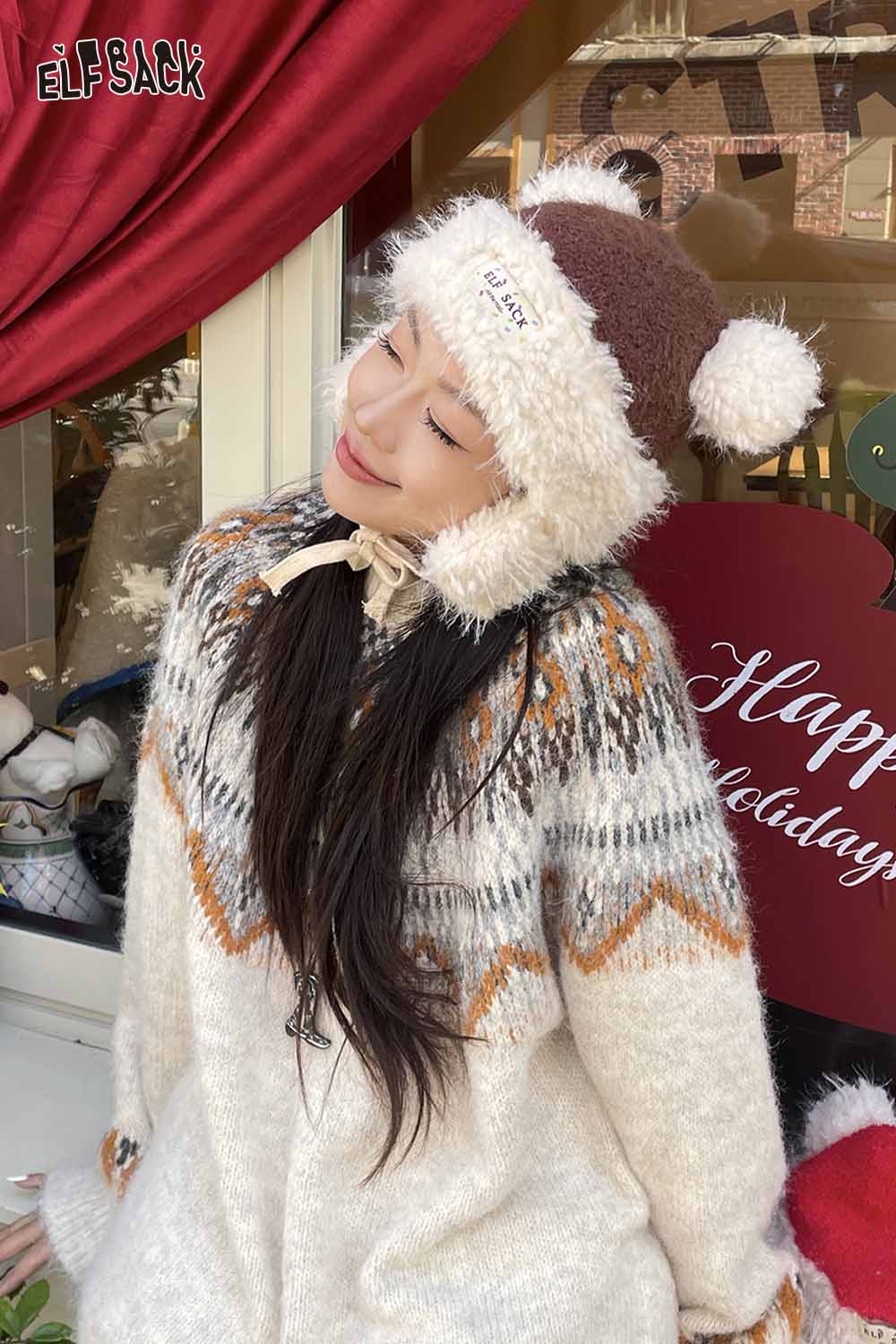 ELFSACK cute plush ear flap hat with pom poms, perfect for stylish winter outfits