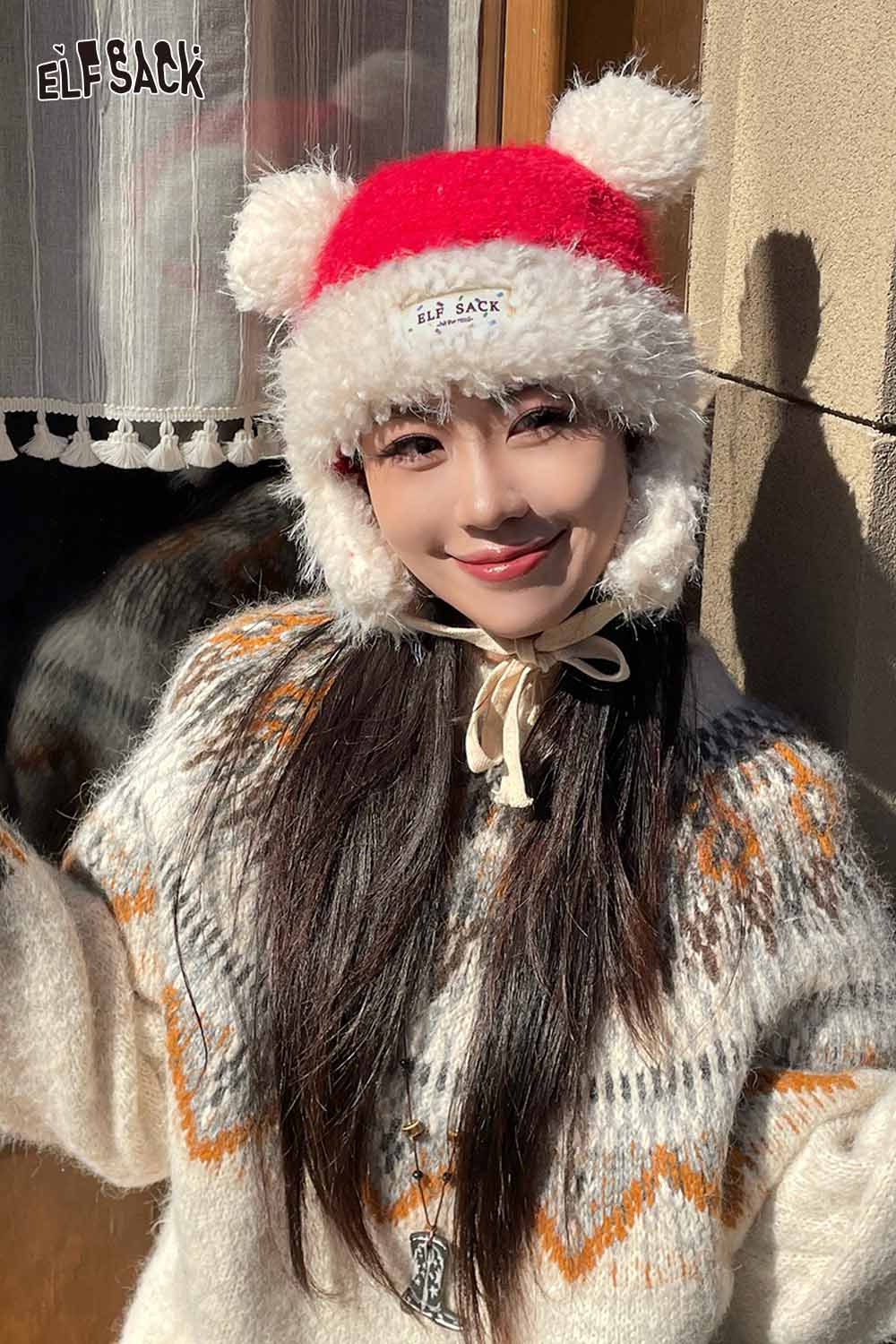 ELFSACK cute plush ear flap hat in red and white with pom-poms for cozy winter style