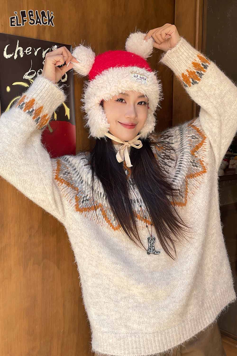 ELFSACK cute plush ear flap hat with pom poms, worn by a young woman in a cozy sweater