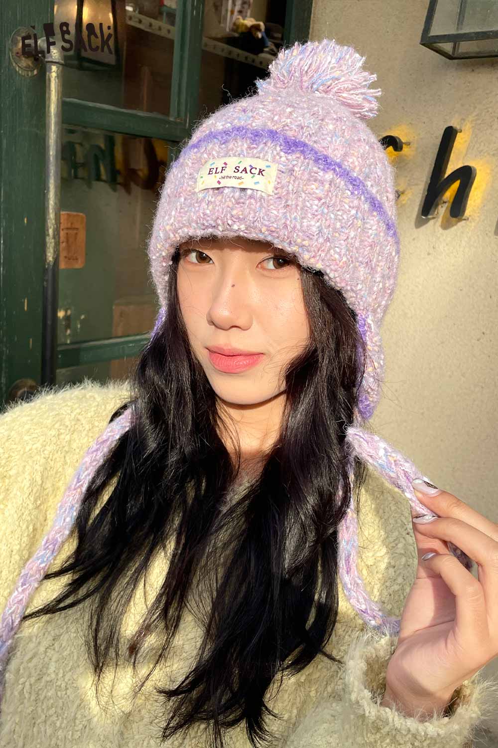 ELFSACK cute striped pom beanie for women in pastel colors with thick yarn and braids