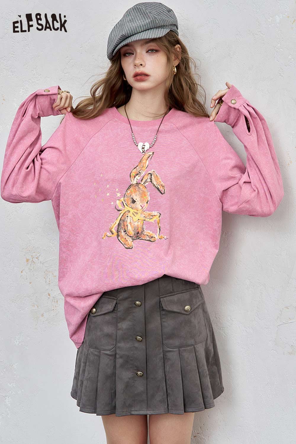 ELFSACK organic cotton embroidered long sleeve tee in pink with unique rabbit design, paired with a stylish gray skirt