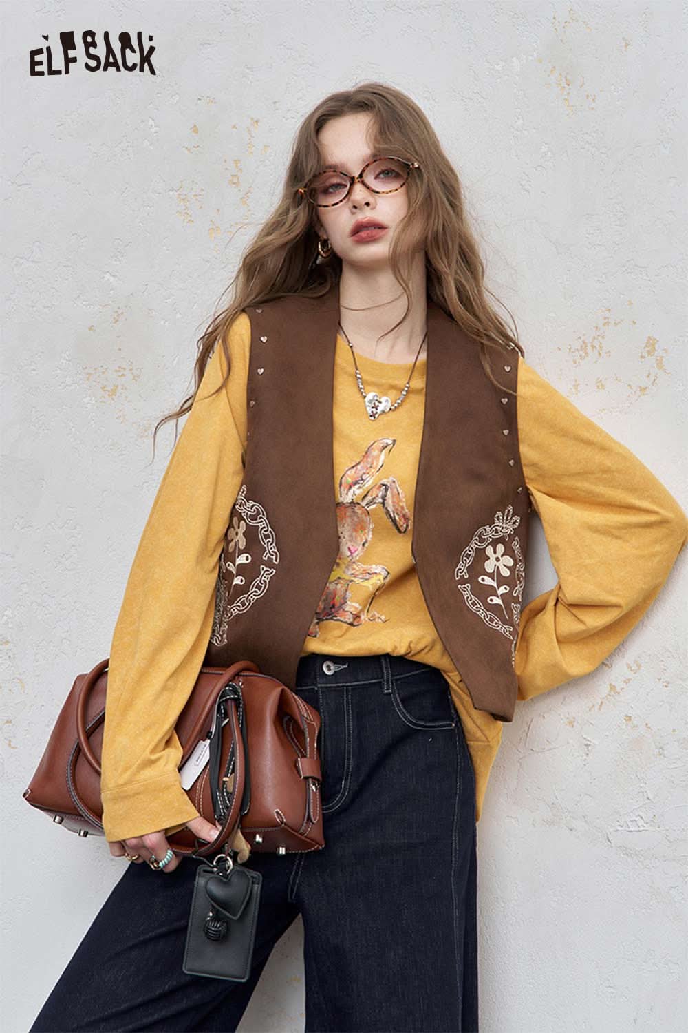 ELFSACK organic cotton embroidered long sleeve tee in mustard yellow paired with a brown vest