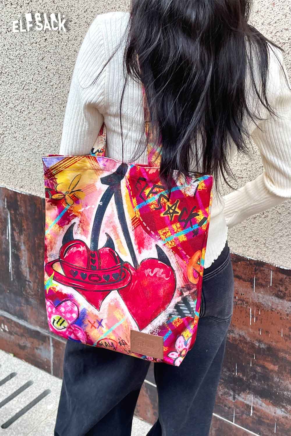 Colorful ELFSACK plaid graffiti tote bag featuring vibrant heart designs and artful patterns