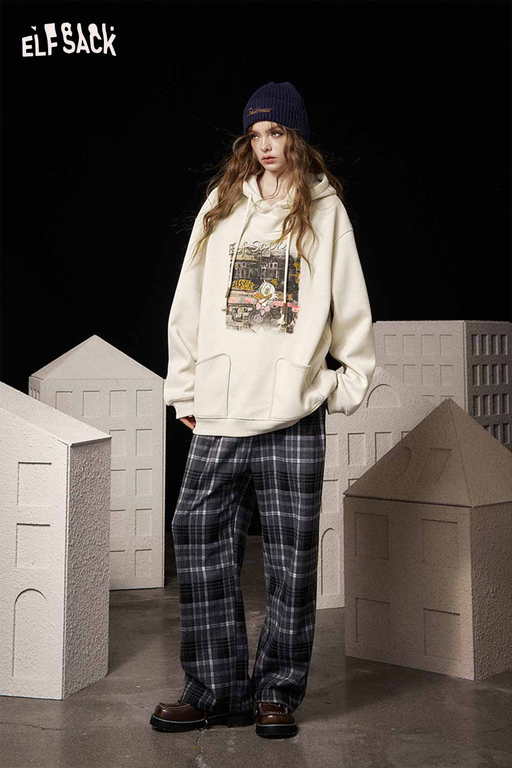 ELFSACK soft graphic hooded sweatshirt in cream color paired with plaid pants for a casual look