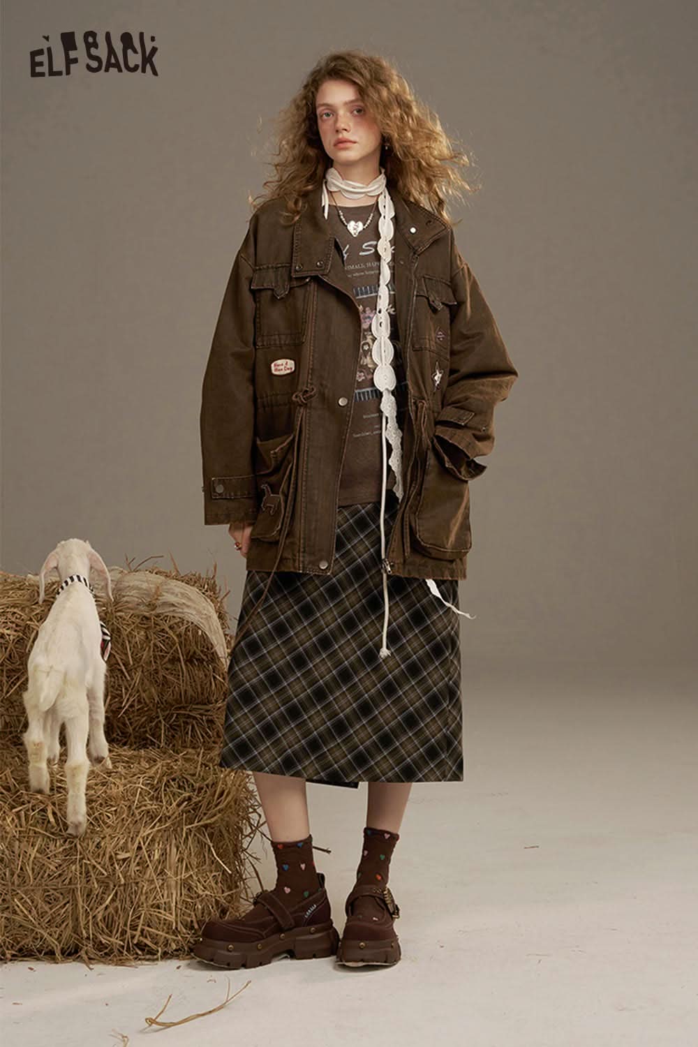 ELFSACK soft printed raglan sleeve sweatshirt styled with a brown jacket and plaid skirt