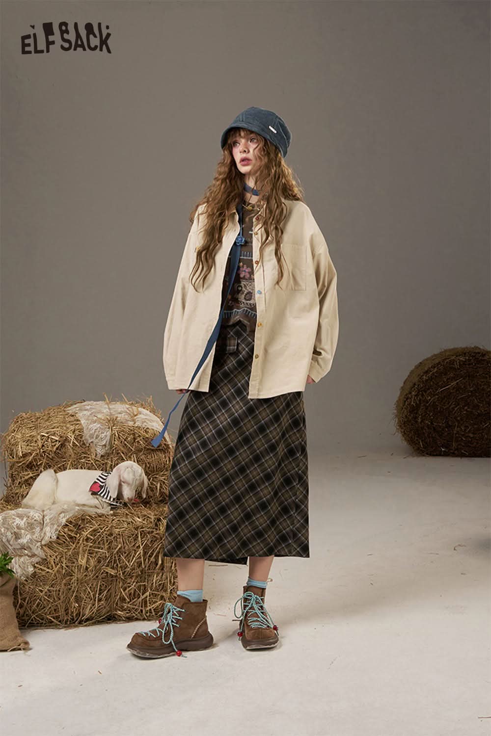 ELFSACK soft printed raglan sleeve sweatshirt styled with a plaid skirt and boots for a casual look