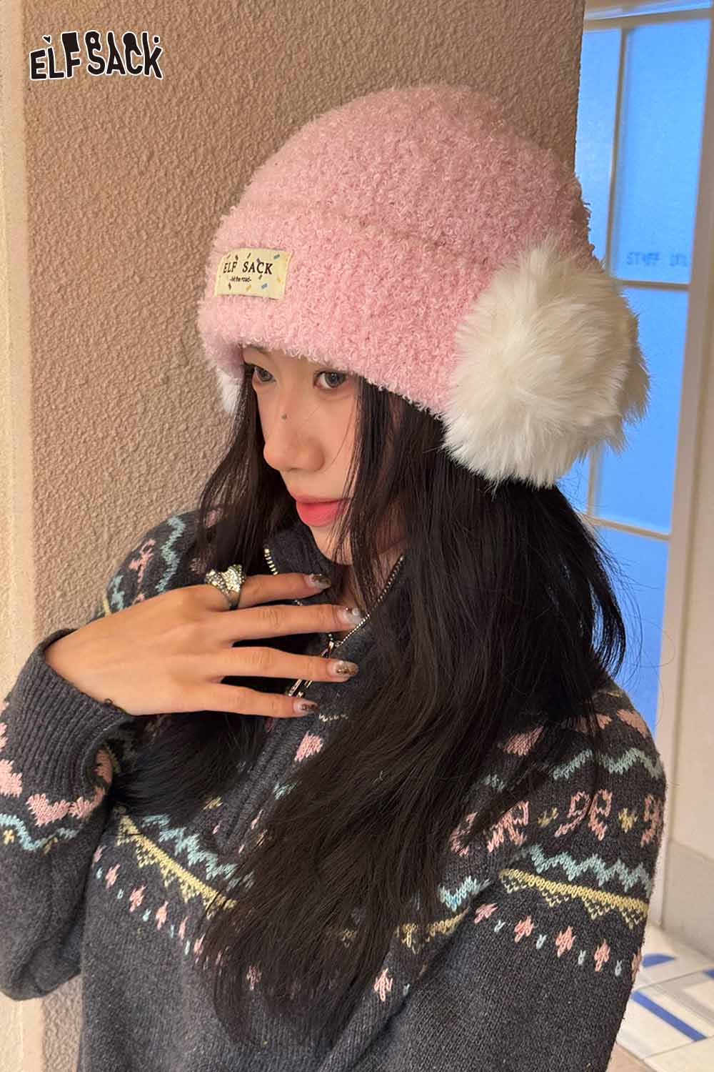 Pink ELFSACK beanie with white plush ear muffs for stylish winter warmth