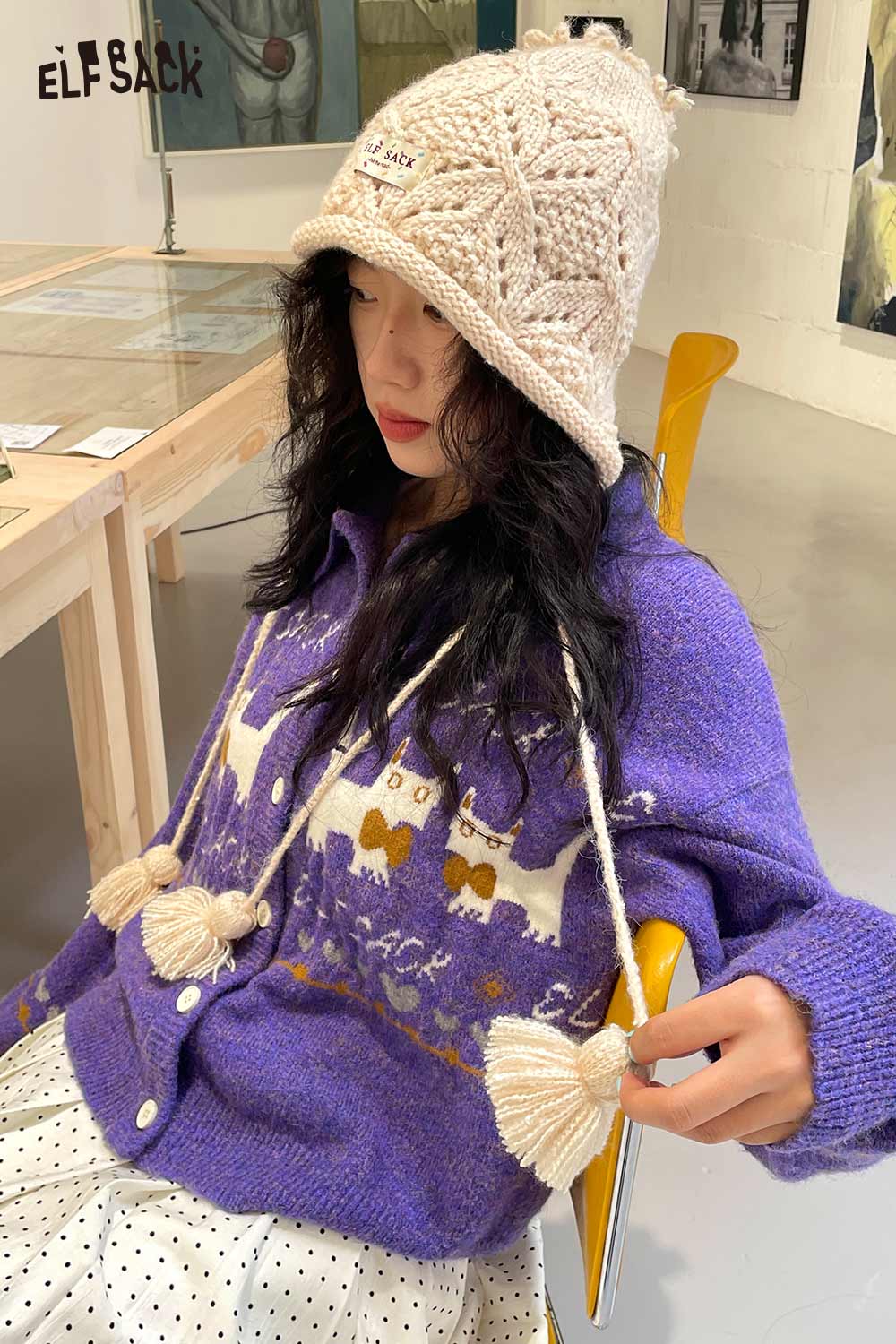 ELFSACK women's braided tassel bucket hat in cream with a cozy sweater for fall fashion