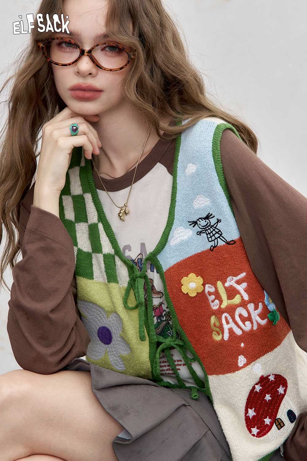 Colorful women's graphic applique vest by ELFSACK featuring playful designs and lace-up details