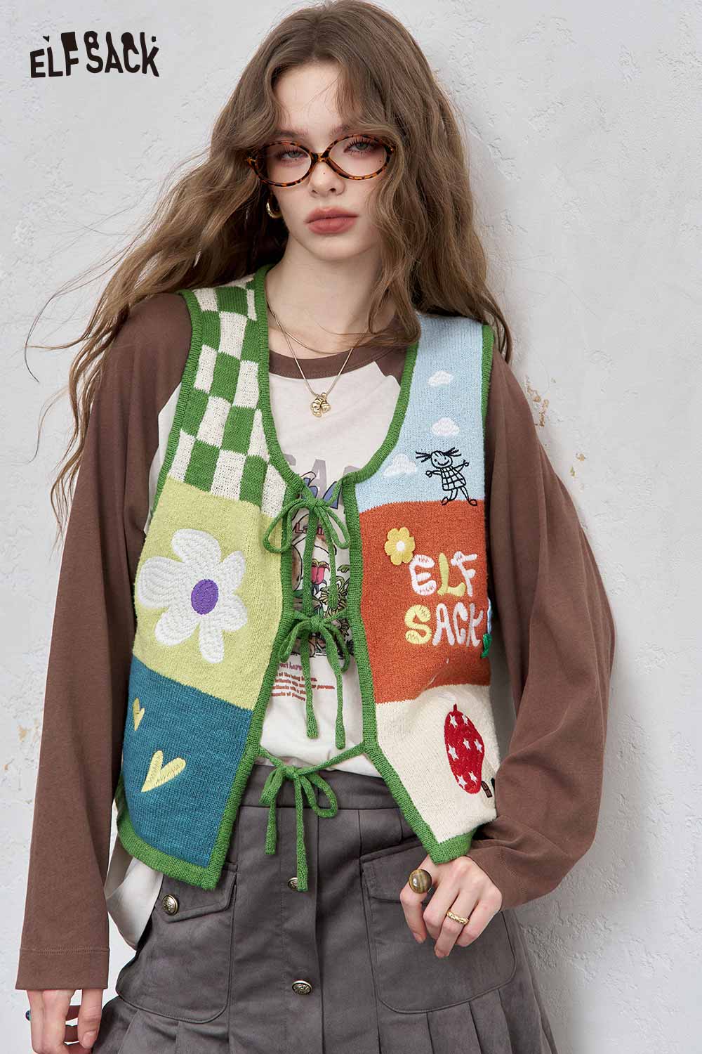Colorful women's graphic applique vest by ELFSACK featuring playful designs and a cozy fit