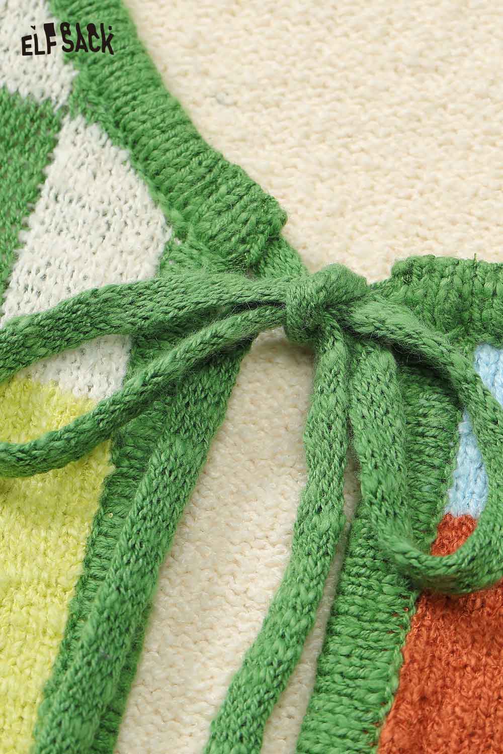 Close-up of ELFSACK women's graphic applique vest featuring intricate knitted details and a stylish tie closure