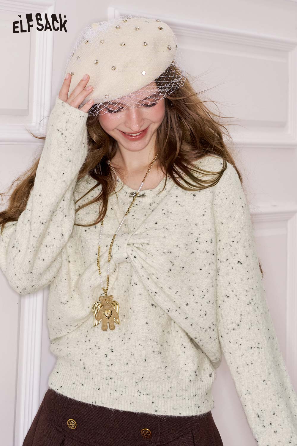 ELFSACK bow embellished cutout sweater in light cream with a twisted front design and textured fabric