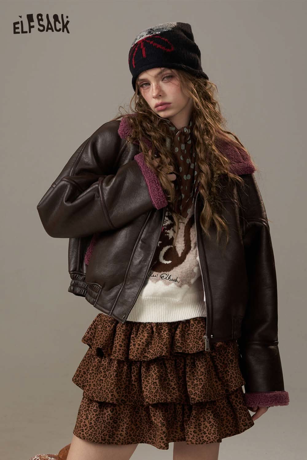 ELFSACK cartoon kitten embroidered sweater styled with a brown leather jacket and leopard print skirt