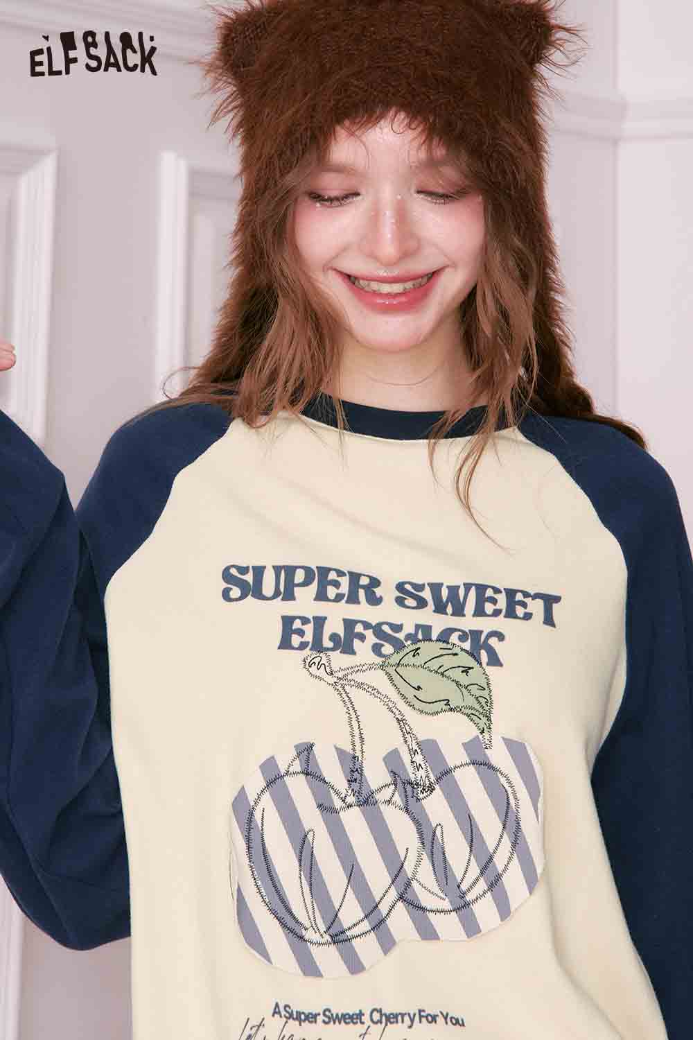 ELFSACK color block raglan sleeve t-shirt in cream and navy featuring a fun graphic design