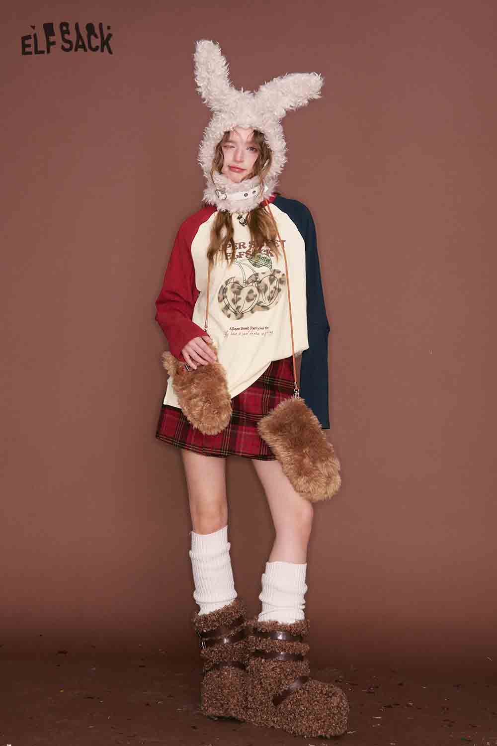 ELFSACK color block raglan sleeve tshirt layered over a plaid skirt for a trendy outfit