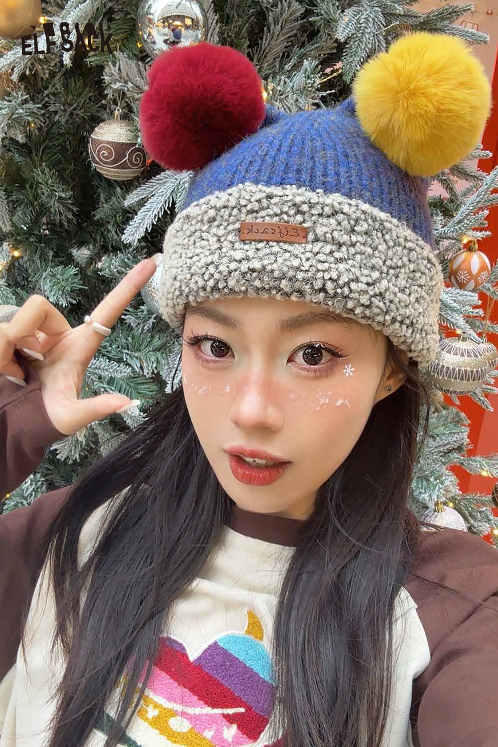 Stylish model wearing a colorful pom pom knit beanie with vibrant colors and a cozy design