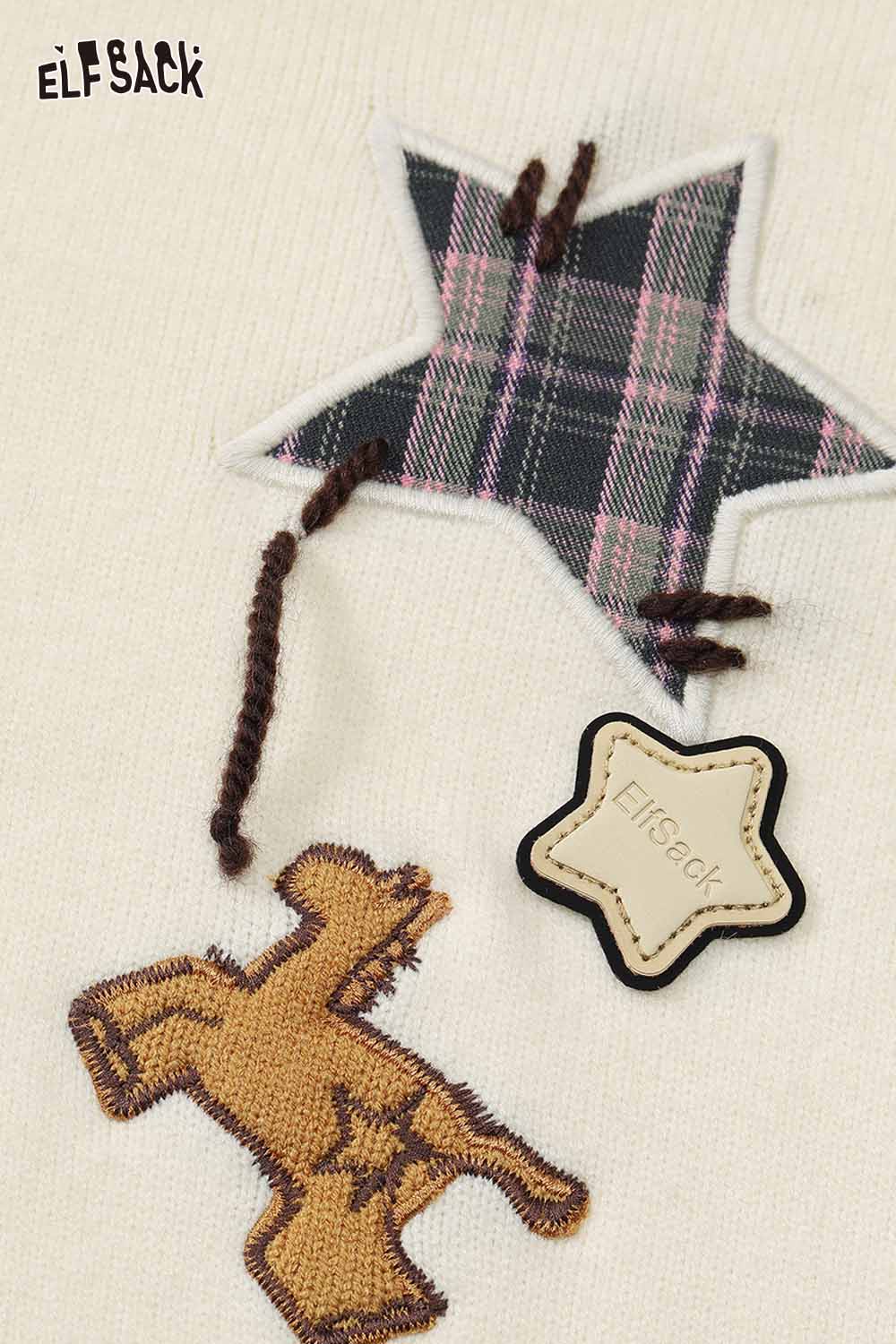 Cute graphic polo neck sweater by ELFSACK with playful star and bear designs
