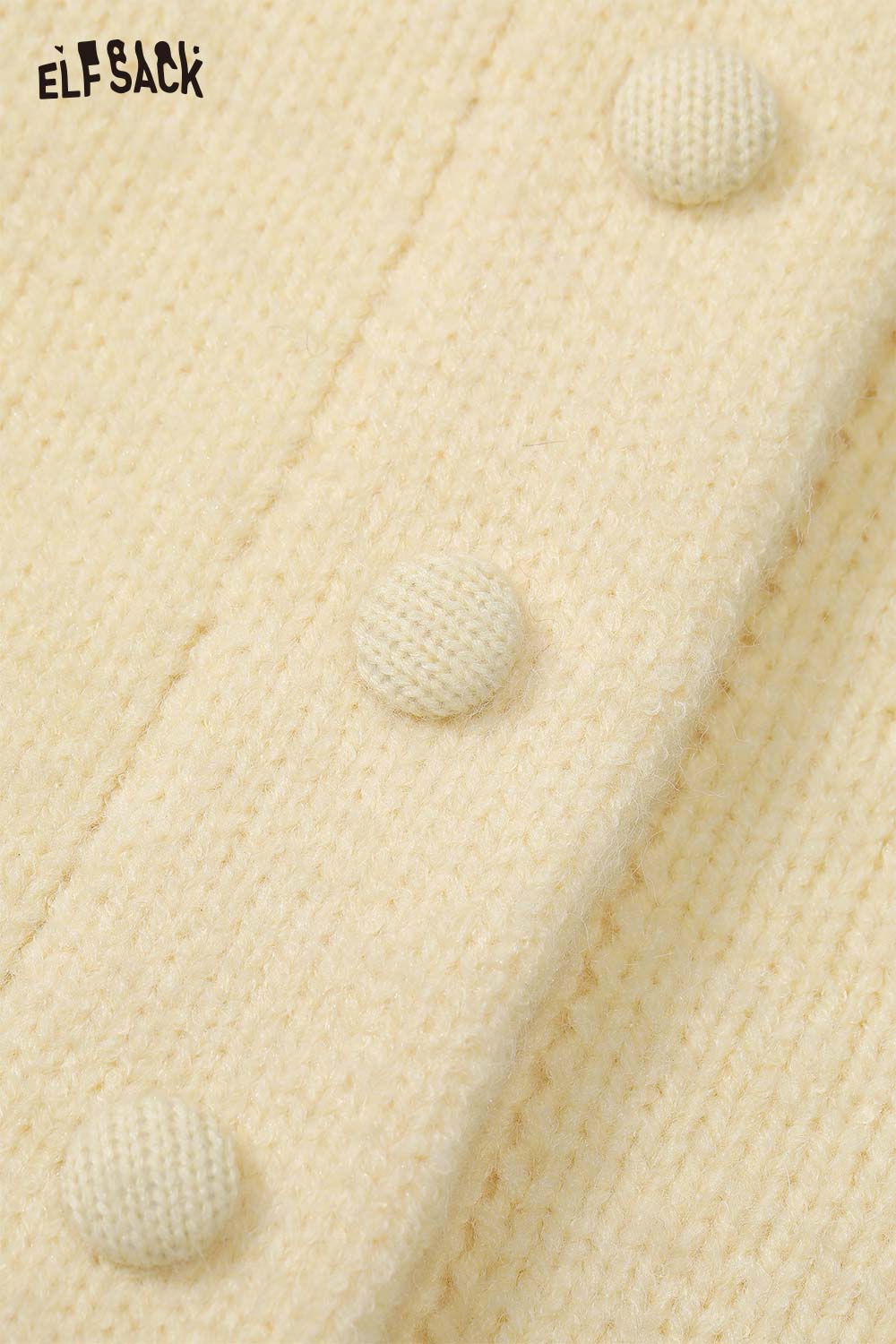 Close-up of a beige cute knit embroidered sweater for women with textured buttons