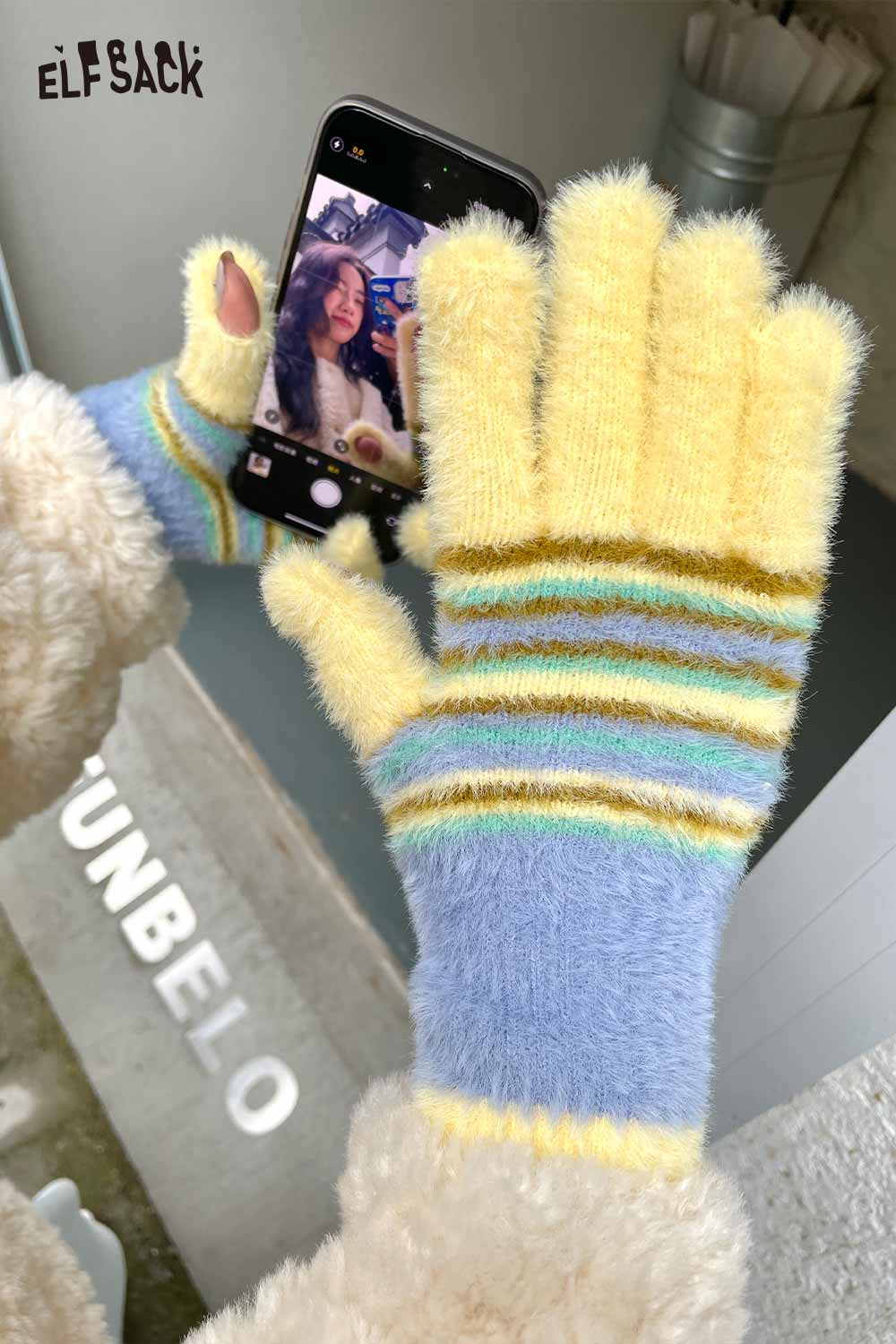 Cute striped finger gloves in yellow and blue, perfect for keeping hands warm while using a phone