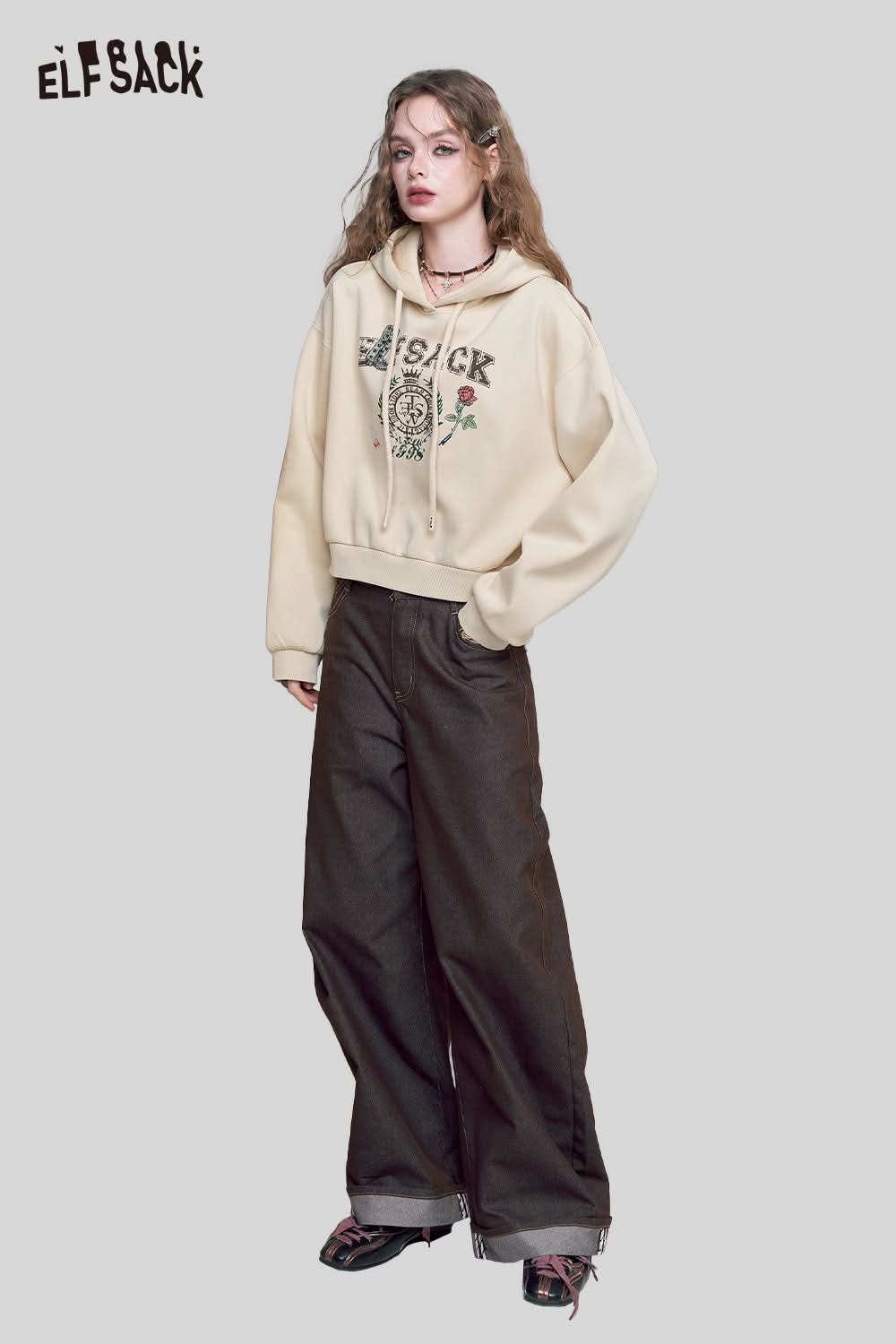 ELFSACK embroidered floral fleece hoodie in cream with floral designs, paired with loose dark pants