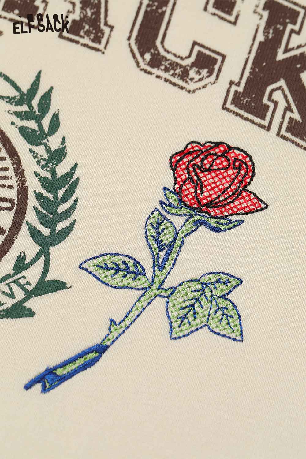Detail of ELFSACK embroidered floral fleece hoodie featuring a rose design in vibrant colors