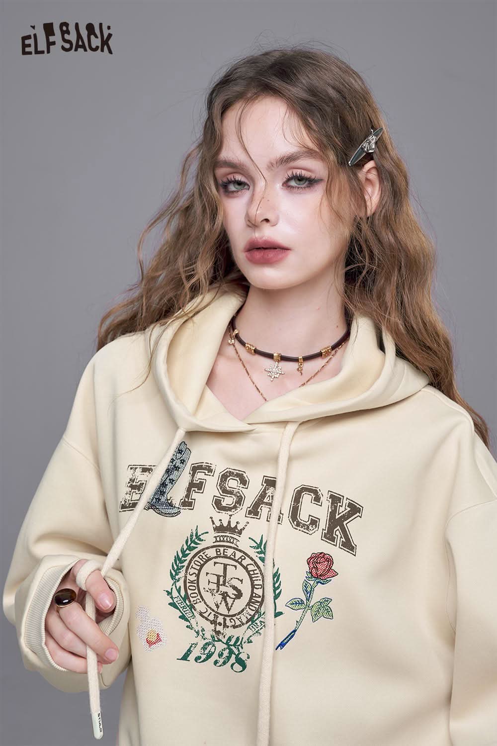 ELFSACK embroidered floral fleece hoodie in cream with stylish graphic design and adjustable drawstrings