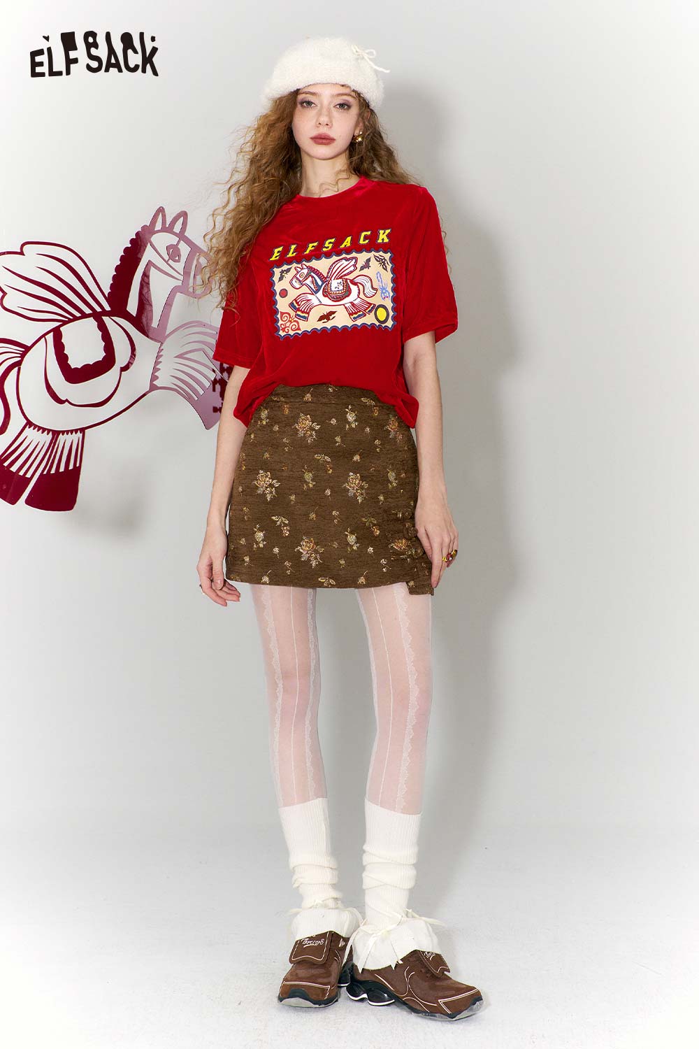 ELFSACK red flying horse print t-shirt styled with a floral skirt and tights for a trendy look