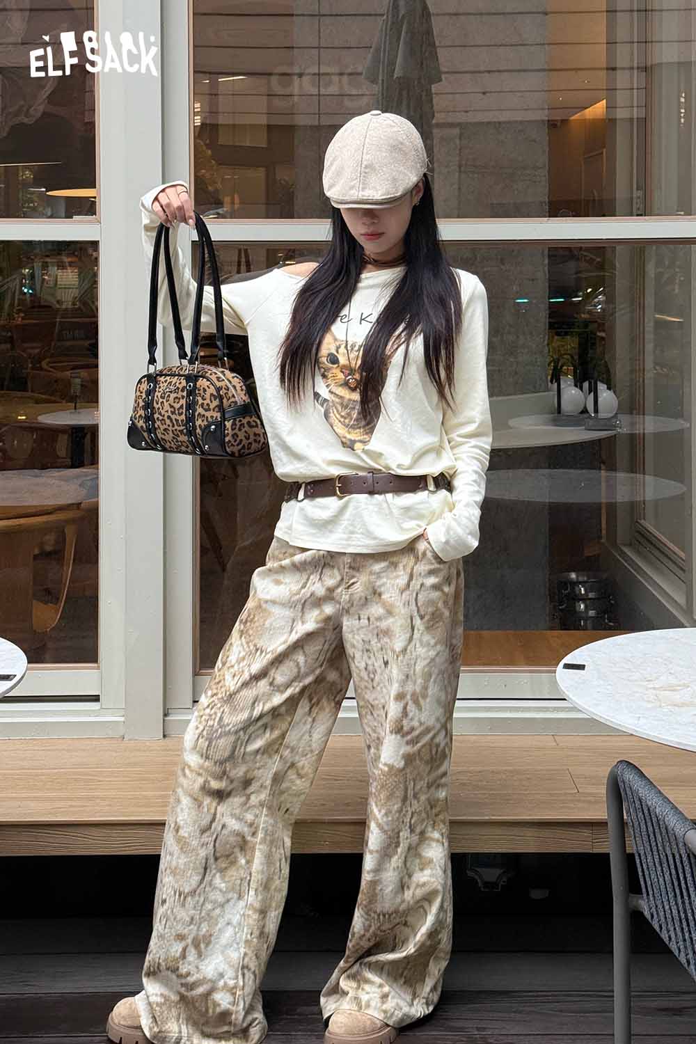 ELFSACK leopard print crossbody bag styled with a relaxed outfit and hat for a trendy look