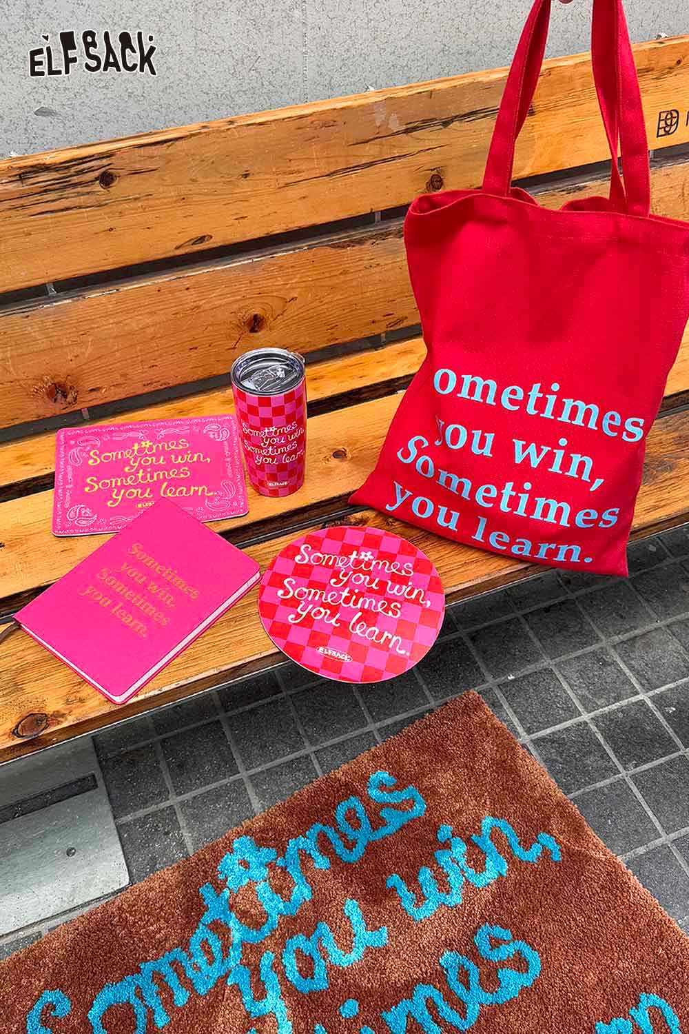 Red ELFSACK tote bag, motivational quote mousepad, notebook, and tumbler set with inspirational phrases