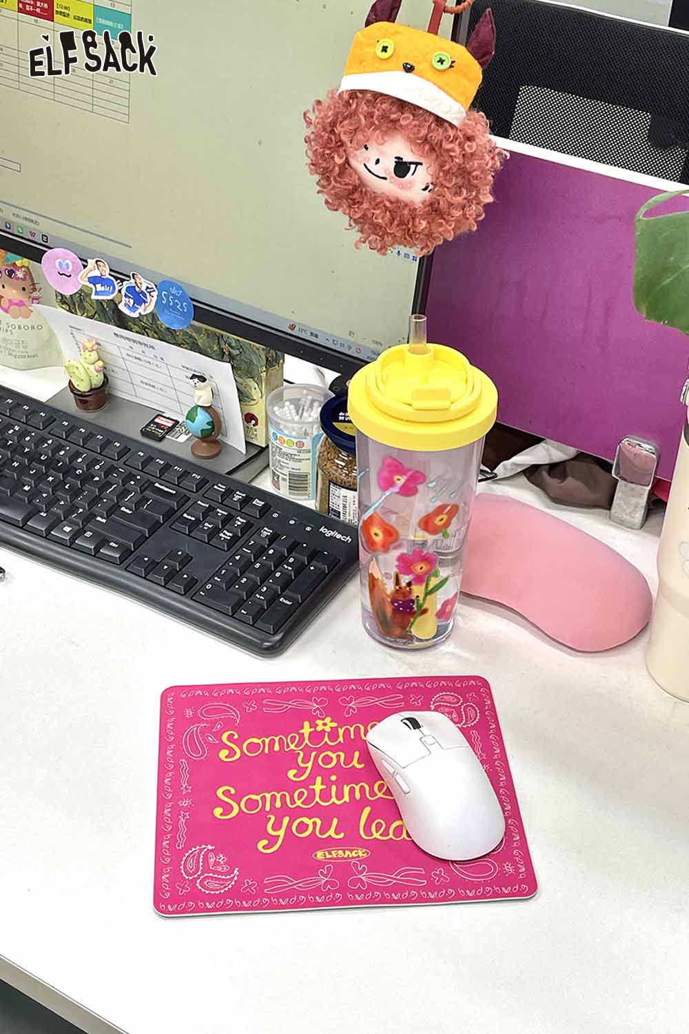 Bright pink motivational quote mousepad with inspiring text and a mouse on an office desk