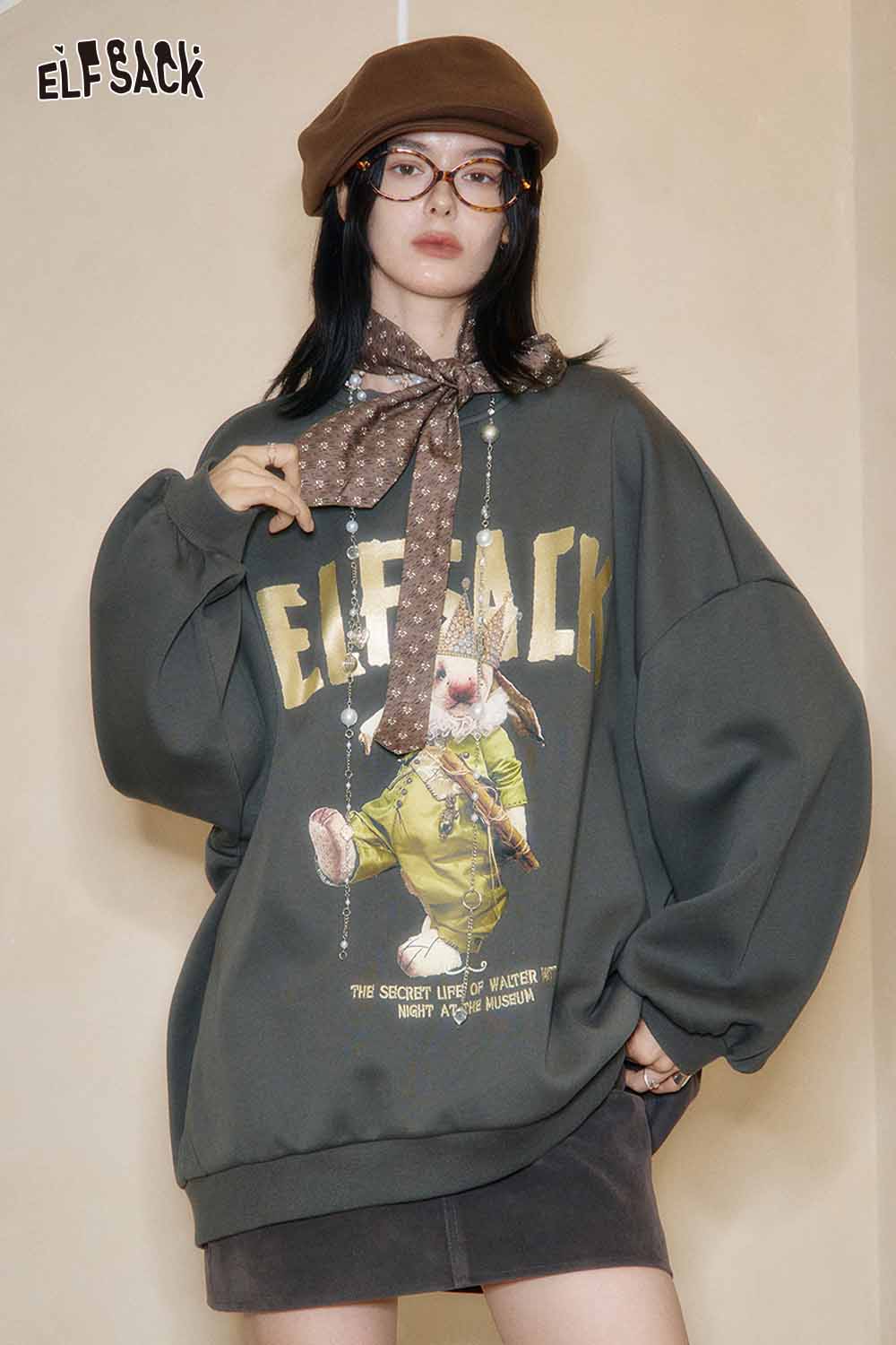 Trendy oversized graphic sweatshirt for women by ELFSACK with unique design and relaxed fit.
