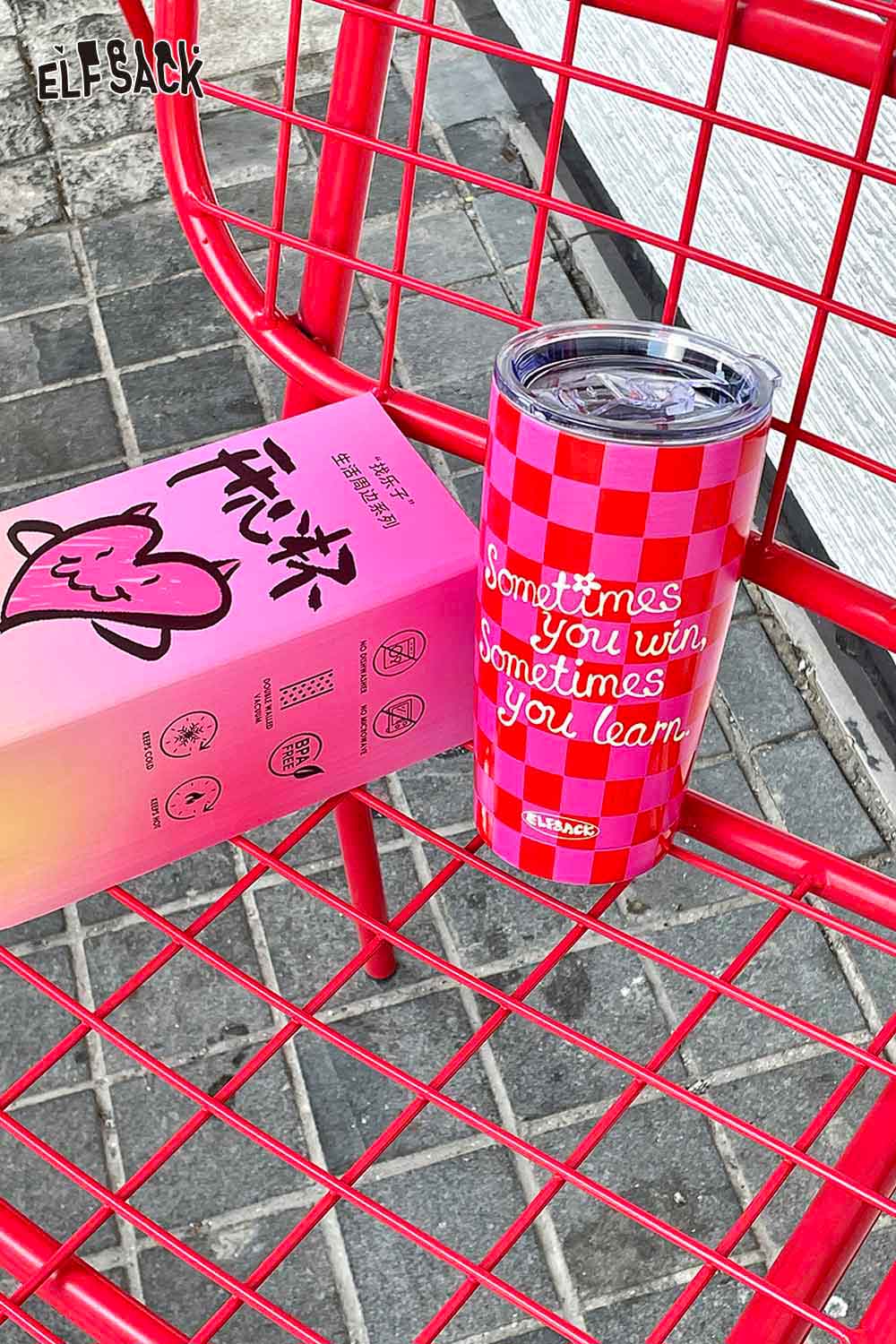 ELFSACK plaid stainless steel tumbler in vibrant colors with motivational quote on a chair