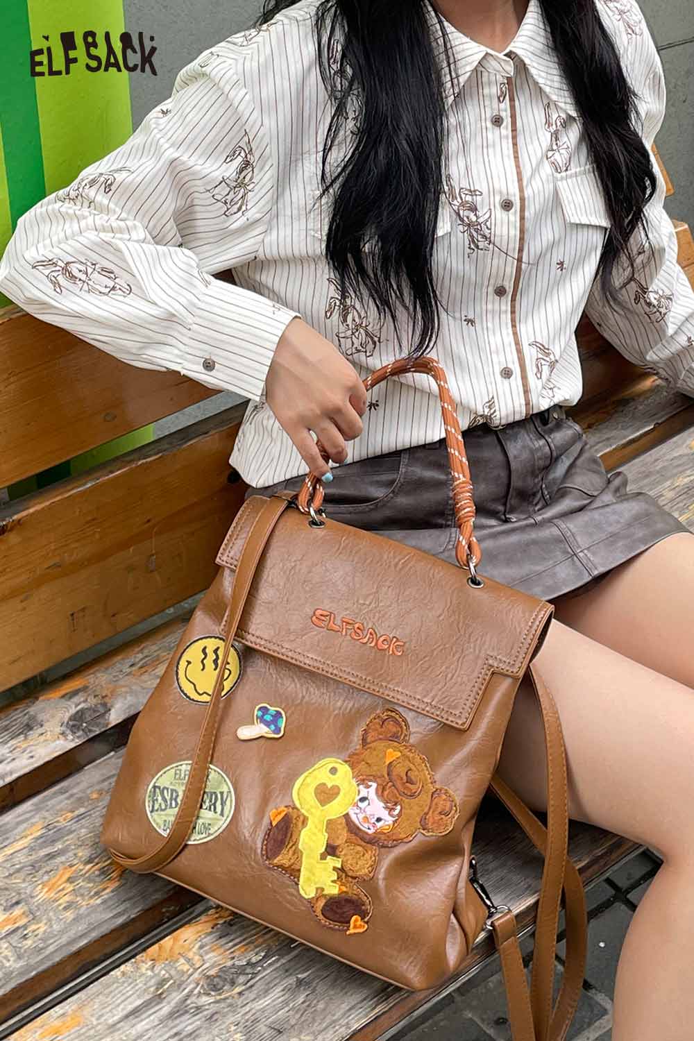 ELFSACK playful embroidery PU leather backpack with colorful patches and a stylish design